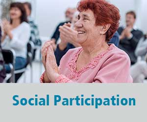 Thumbnail image for Social Participation domain. Image is of a group of people clapping at the end of a presentation. An older woman smiles and claps in the foreground.